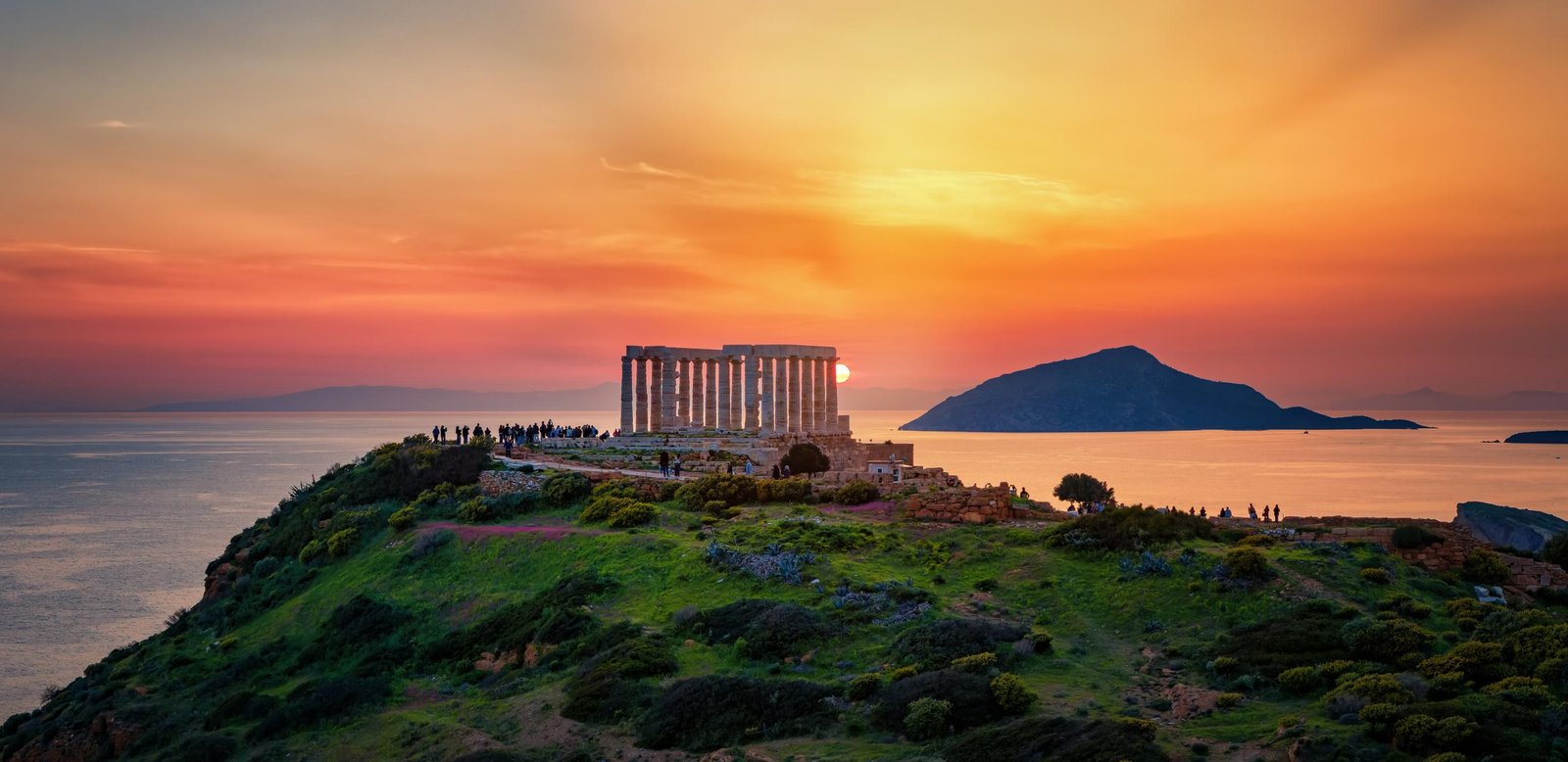 Temple of Poseidon at Cape Sounion overlooking the Aegean Sea at sunset